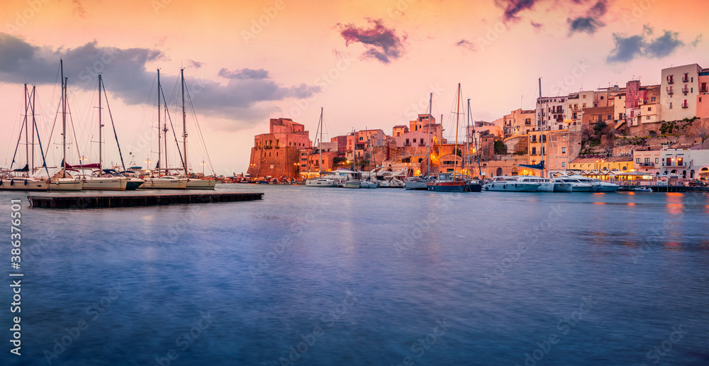 Colorful evening cityscape of Castellammare del Golfo town. Splendid sunset on Mediterranean sea. Wonderful scene of Sicily, Trapani Province, Europe. Traveling concept background.