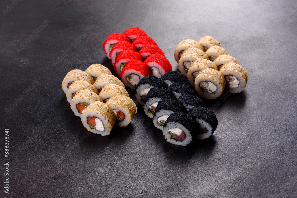 Fresh delicious beautiful sushi rolls on a dark background Fresh delicious beautiful sushi rolls on a dark background