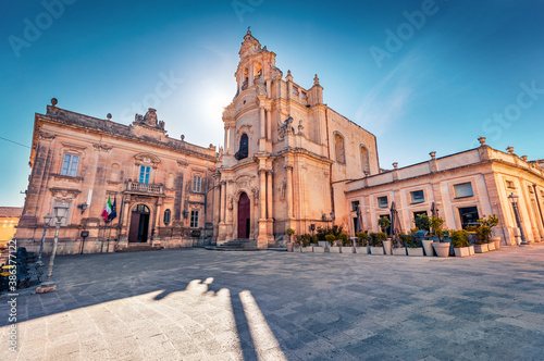 Empty Piazza Duomo square with Duomo San Giorgio - baroque Catholic church. Spectacular morning cityscape of Ragusa, Sicily, Italy, Europe. Traveling concept background. Wide angle picture.