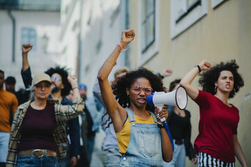 Group of people activists protesting on streets, strike and demonstration concept.