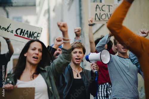 Group of people activists protesting on streets, strike and demonstration concept. photo