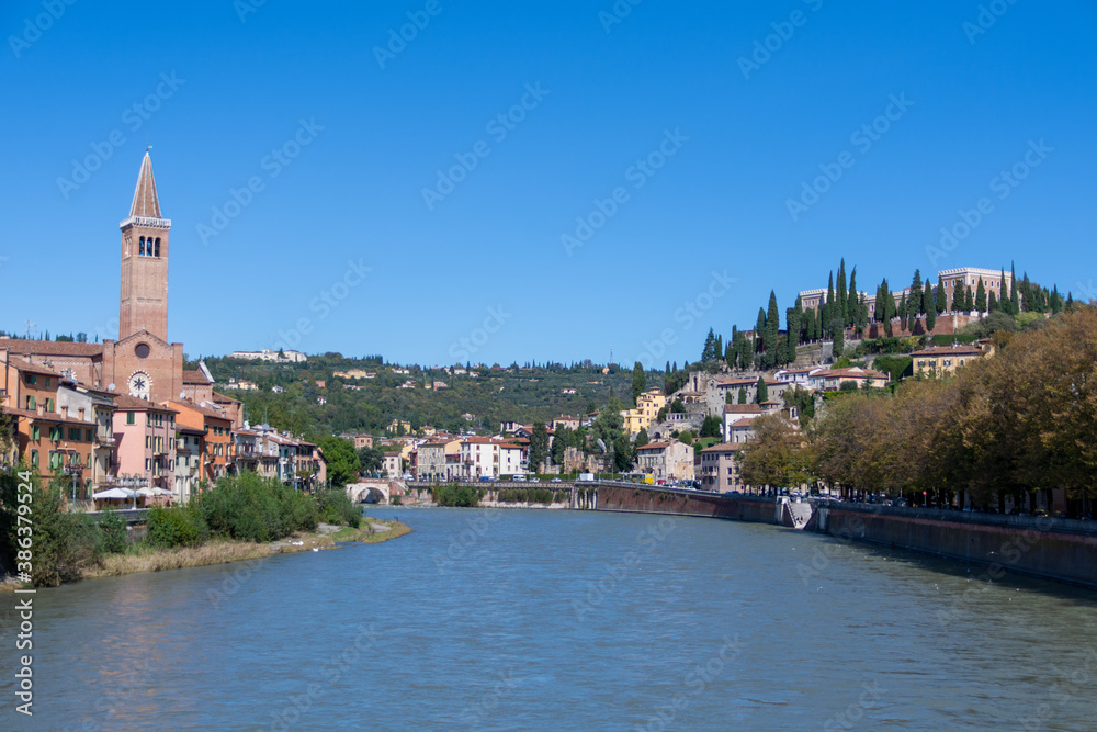 View of the Adige River with the Anastasia Basilica in the background in Verona, Italy