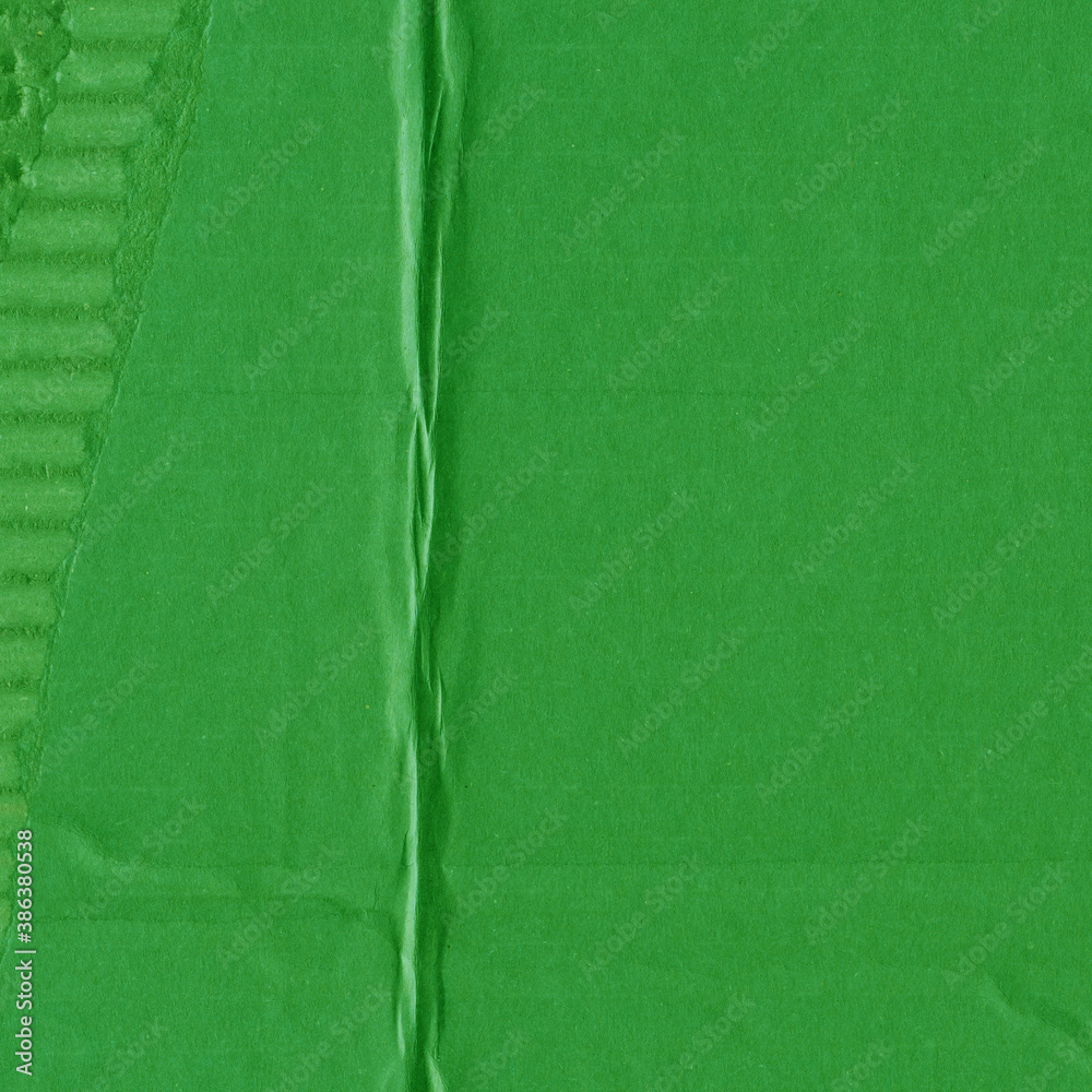 Fototapeta premium A green vintage rough sheet of carton. Recycled environmentally friendly cardboard paper texture. Simple and bright minimalist papercraft background.