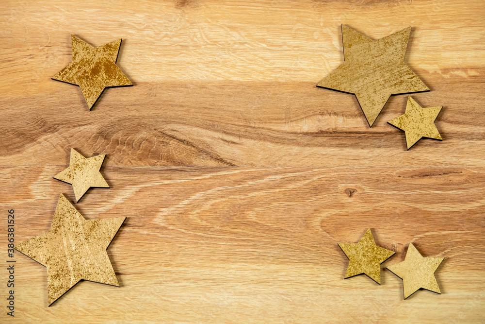 close-up of square frame with glossy gold stars on wooden background, christmas decoration, flat lay close-up of square frame with glossy gold stars on wooden background, christmas decoration, flat lay