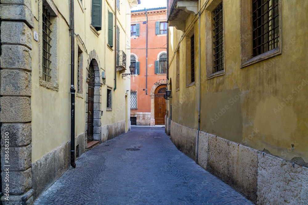 Narrow empty street in the old medieval town of Verone in the Veneto Region, Italy. 