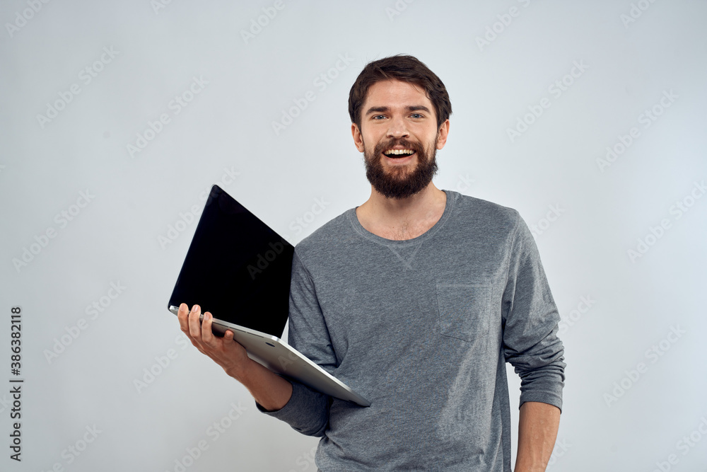 man holding laptop technology internet work communication light background man holding laptop technology internet work communication light background