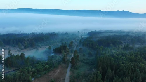 Forests and mountains of the Southern Urals near the village of Tyulyuk in Russia early in the morning. Drone view. photo