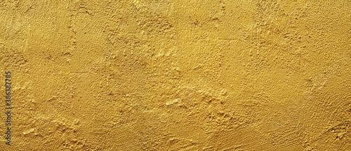 Golden wall texture rough background abstract concrete floor or Old cement grunge background with Gold empty.