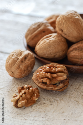 Close up shot of walnuts on a white wooden table