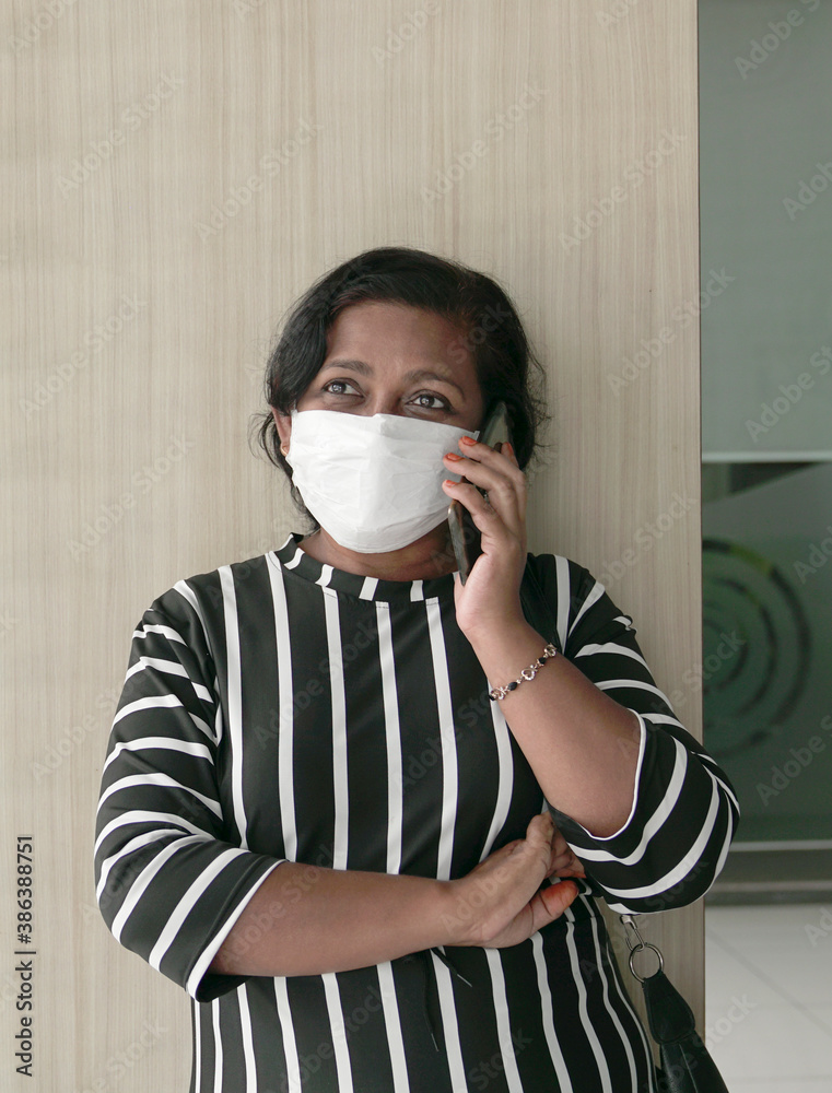 Portrait of a woman wearing face mask talking on the cellphone