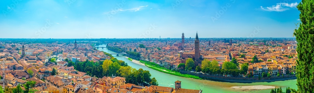 Panorama of Verona historical city centre, bridges across Adige river, Basilica di Santa Anastasia, medieval buildings with red tiled roofs, Veneto Region, Italy. Panoramic view of Verona cityscape