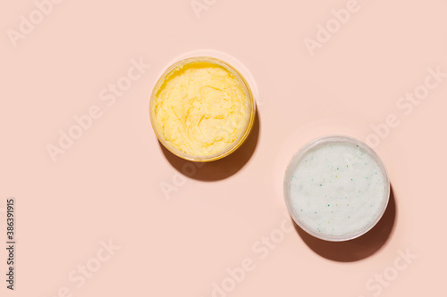 Body scrub in a jar on a beige background. View from above. Copy space