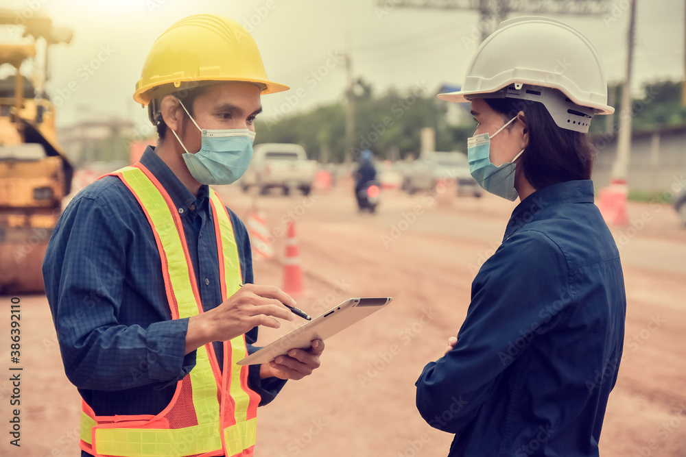 Two Engineer holding tablet talking on site construction Two Engineer holding tablet talking on site construction