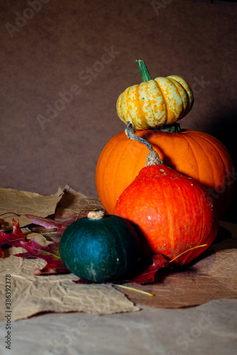 Bright pumpkins on the table on craft paper