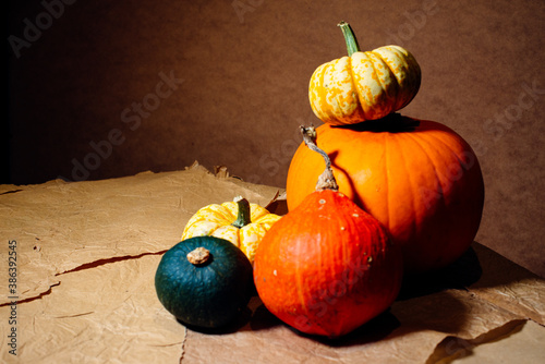 Bright pumpkins on the table on craft paper