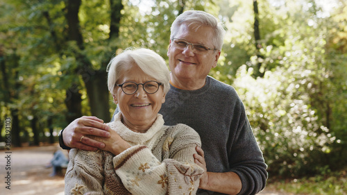 Фотография Happy old couple hugging in park