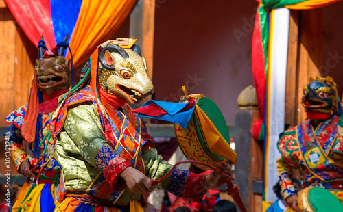 Bhutan, in the village of Bumthang, a monk mask dancer in his colourful costume dances at the festival of Jakar.