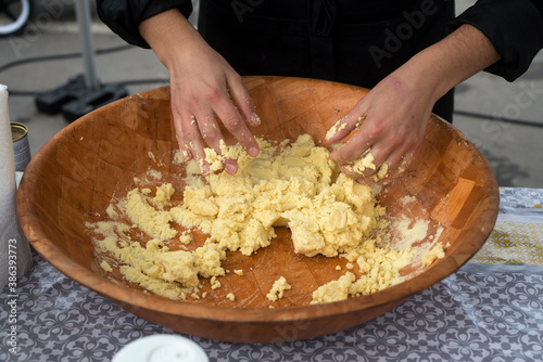 Closeup of hands of algerian woman making msemens at the market