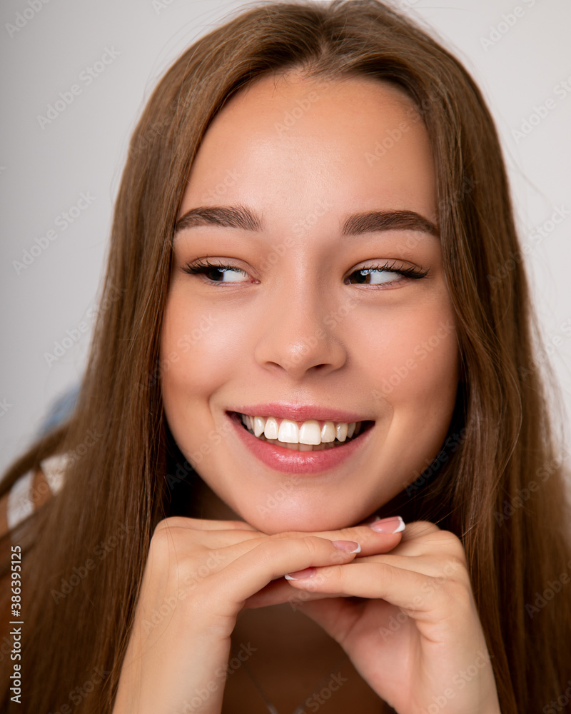 beautiful young girl woman openly smiling snow-white smile. Healthy, even teeth, clean skin. Dental concept. Close up Studio portrait beautiful young girl woman openly smiling snow-white smile. Healthy, even teeth, clean skin. Dental concept. Close up Studio portrait