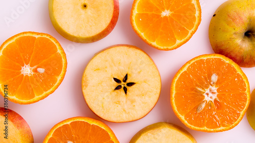 Apple and orange slices on a white background 