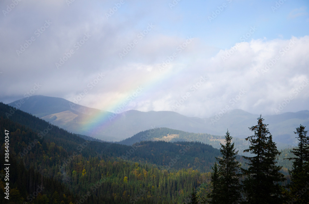 Autumn landscape in the mountains with a rainbow. Carpathian Mountains, Ukraine.