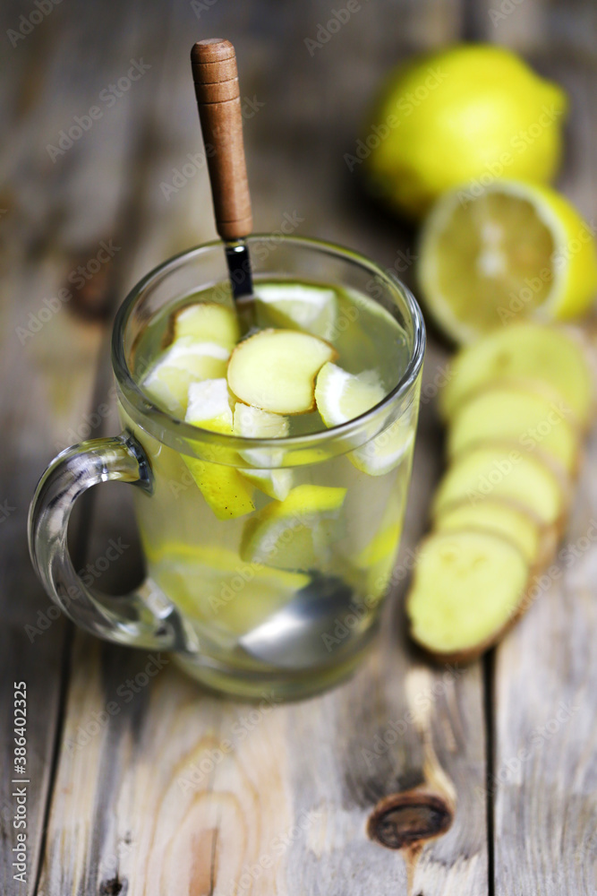 Ginger lemon drink in a glass mug. A healthy hot drink for colds and viruses. Home remedies for colds Ginger lemon drink in a glass mug. A healthy hot drink for colds and viruses. Home remedies for colds