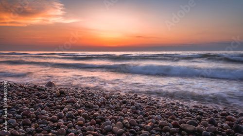 Colorful sunset over the sea and rocky shore