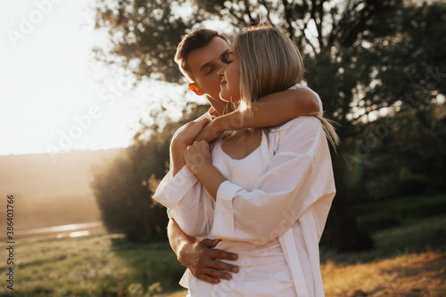 Obraz na płótnie Close up portrait of cute lovely couple enjoying each other with closed eyes. Man kissing him girlfriend on the cheek. w salonie