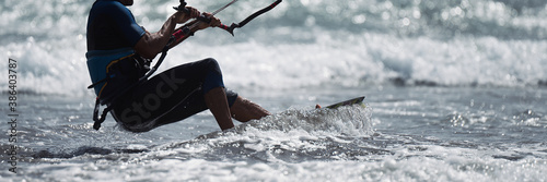 Athletic man jump on kite surf board on a sea waves	