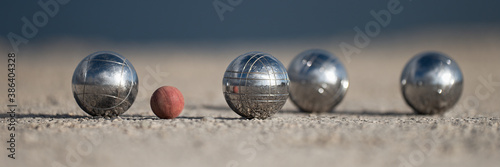 Metallic petanque four balls and a small wood jack photo