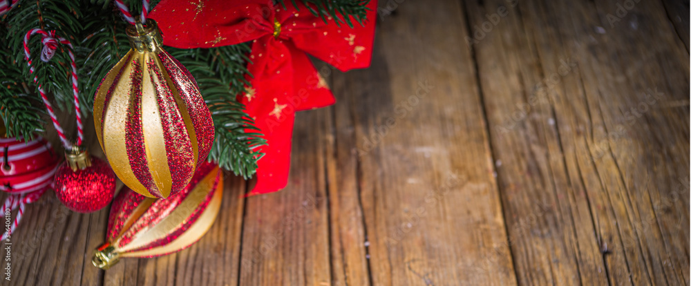 Fototapeta premium Christmas holiday background. Decorated christmas tree with traditional ball and toys, gift boxes over wooden background copy space