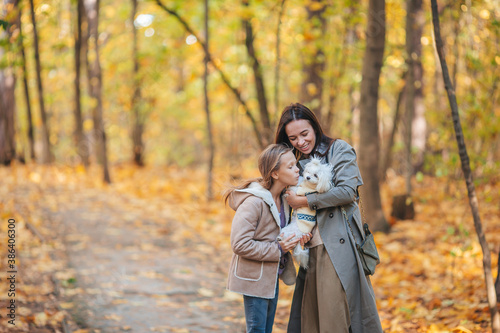 Little girl with mom outdoors in park at autumn day © travnikovstudio
