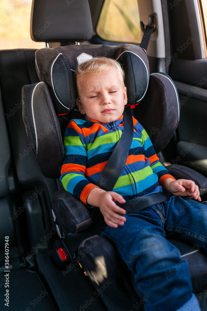Little baby boy sleeping in his car seat buckled up in the car. Little baby boy sleeping in his car seat buckled up in the car.