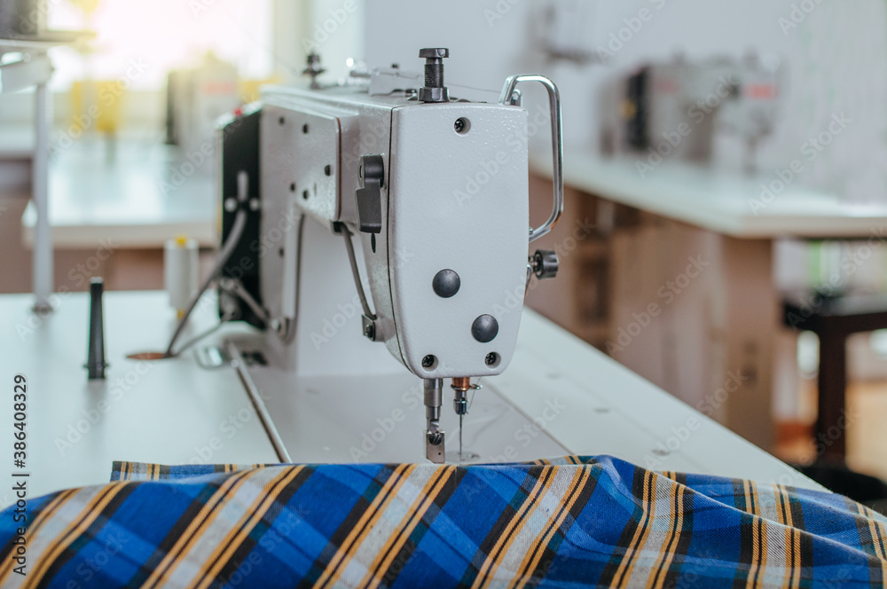 Fototapeta premium Sewing machine with fabric in sewing factory
