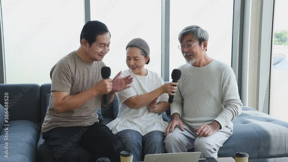 Group of senior elderly asian people in casual outfit reunion meeting with old friend together sing a song with happy and smile emotion in living room Group of senior elderly asian people in casual outfit reunion meeting with old friend together sing a song with happy and smile emotion in living room