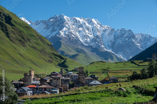 Ancient authentic village Ushguli, the Svaneti UNESCO World Heritage Site and one of the highest settlements in Europe. Bezengi wall and mount Shkhara, the highest mount in Georgia, on the background.