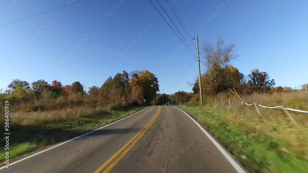 A forward driving view on typical Ohio country roads. Colorful Autumn foliage on the trees. Shot at 60fps for optional slow motion use. A forward driving view on typical Ohio country roads. Colorful Autumn foliage on the trees. Shot at 60fps for optional slow motion use.