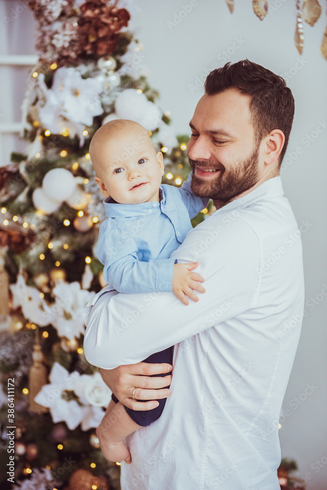 Happy young father with his sweet baby at christmas