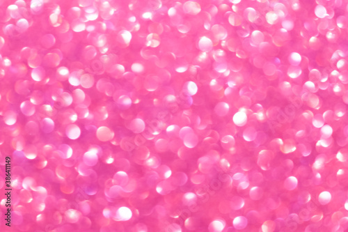 An abstract pink background with sparkle lights and bokeh. Pink blurred light.