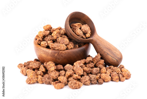 Tigernuts isolated on white background. Chufa nuts or tiger nuts in wooden bowl and spoon. photo