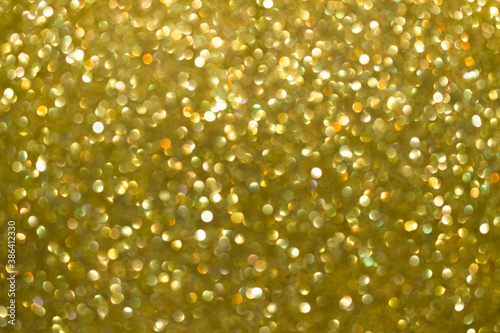 An abstract gold background with sparkle lights and bokeh. Gold blurred light.