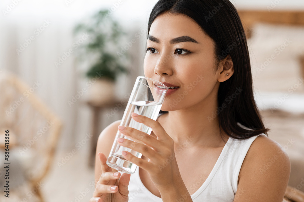 Young attractive asian woman drinking water, copy psace Young attractive asian woman drinking water, copy psace
