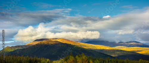 Fototapeta Naklejka Na Ścianę i Meble -  Panoramic autumn landscape in the Brooks Range, Alaska with mountains partly shrouded in clouds 