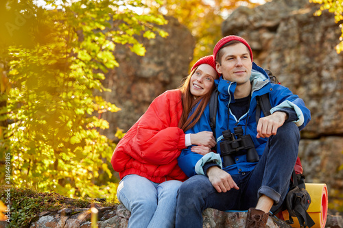 caucasian couple camping, active romantic couple in love traveling and hiking. tourists are exploring together. sunny autumn day