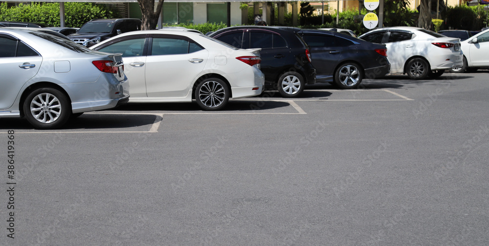 Closeup of rear side of soft blue car with other cars parking in outdoor parking area in bright sunny day. Closeup of rear side of soft blue car with other cars parking in outdoor parking area in bright sunny day.