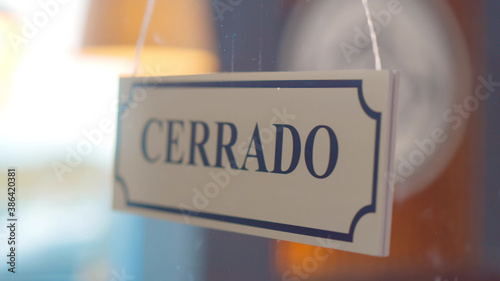 Close up cerrado sign hanging on glass door of cafe
