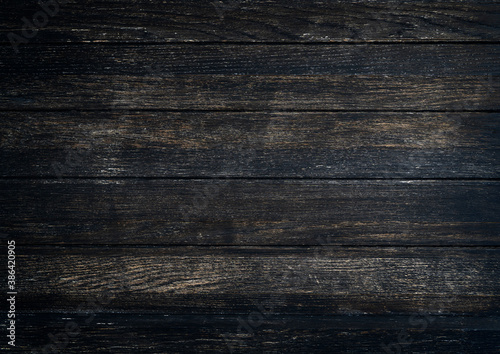 Grunge dark wood plank texture background. Vintage black wooden board wall antique cracking old style background objects for furniture design. Painted weathered peeling table wood hardwood decoration.