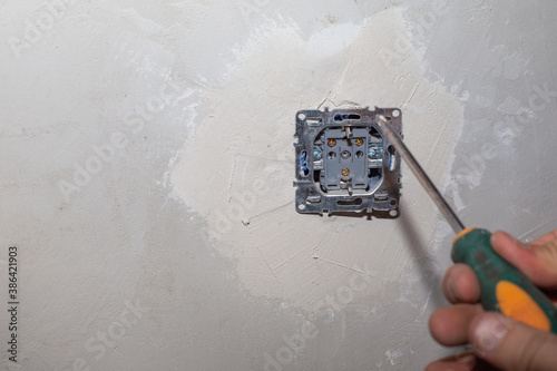 installation and repair of an electrical outlet on a cement wall