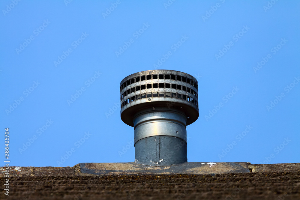 Gas fire metal galvanized flue fitted as a replacement ridge tile to the roof of a domestic house Gas fire metal galvanized flue fitted as a replacement ridge tile to the roof of a domestic house