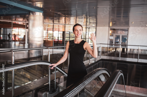 Woman greeting her acquaintance at the airport photo